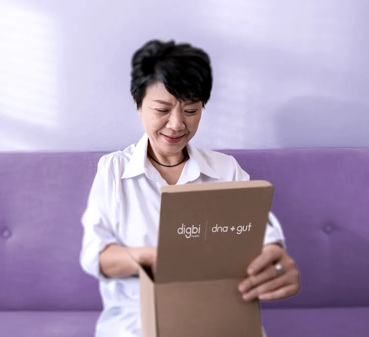 A Digbi member opening her DNA and gut test kit at home